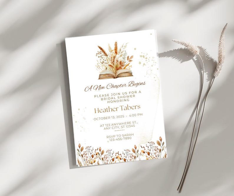 Op de afbeelding: Een witte uitnodigingskaart met gouden tekst en een aquarel-illustratie van een boek met herfstbladeren. De tekst luidt "A New Chapter Begins", "Please join us for a bridal shower honoring Heather Tabers", "October 13, 2025 - 4:00 PM", "At 123 Anywhere St., Any City, ST 12345", "RSVP to Sarah 123-456-7890".