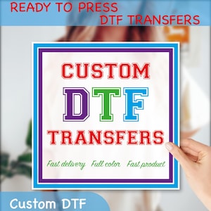 May include: A square sign with the words "CUSTOM DTF TRANSFERS" in red, green, blue, and purple. The sign also includes the phrases "Ready to Press" and "Fast delivery Full color Fast product."