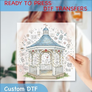 May include: A square DTF transfer featuring a detailed illustration of a gazebo with a blue roof, fairy lights, and various themed icons. The text "READY TO PRESS DTF TRANSFERS" and "Custom DTF" are displayed.