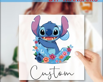 May include: A square DTF transfer featuring the character Stitch from Lilo & Stitch. Stitch is blue with large ears, smiling, and surrounded by flowers and water. The word "Custom" is written in cursive below the image. The text "READY TO PRESS DTF TRANSFERS" is at the top.