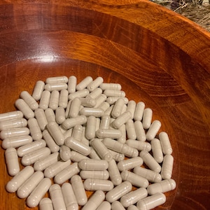 May include: A set of three ceramic mugs with a speckled, matte finish. The mugs are in shades of cream, light gray, and dark gray. Each mug has a simple, modern design and a rounded handle.