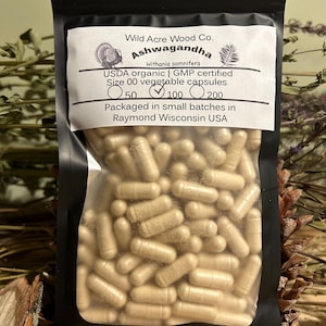 May include: A resealable bag of Ashwagandha capsules, labeled "Wild Acre Wood Co. Ashwagandha Withania somnifera USDA organic | GMP certified Size 00 vegetable capsules 50 100 200 Packaged in small batches in Raymond Wisconsin USA"