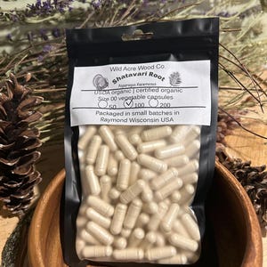 May include: A clear plastic bag filled with beige capsules labeled "Shatavari Root Asparagus Racemosus USDA organic certified organic Size 00 vegetable capsules 50 100 200 Packaged in small batches in Raymond Wisconsin USA"