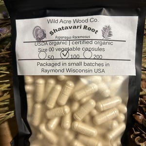May include: A resealable plastic bag filled with beige capsules labeled "Shatavari Root Asparagus Racemosus USDA organic | certified organic Size 00 vegetable capsules 50 100 200 Packaged in small batches in Raymond Wisconsin USA"