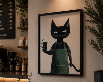 May include: A framed wall print featuring a black cat wearing a green apron and holding a coffee mug. The cat has pointed ears, white eyes, and a long tail. The print is displayed on a beige wall inside a coffee shop with a menu board and table.