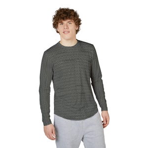 May include: A long-sleeved shirt with a repeating chainmail pattern in shades of gray. The shirt has a crew neck and a curved hemline. The person is wearing gray sweatpants. The shirt is made of a soft, comfortable material.