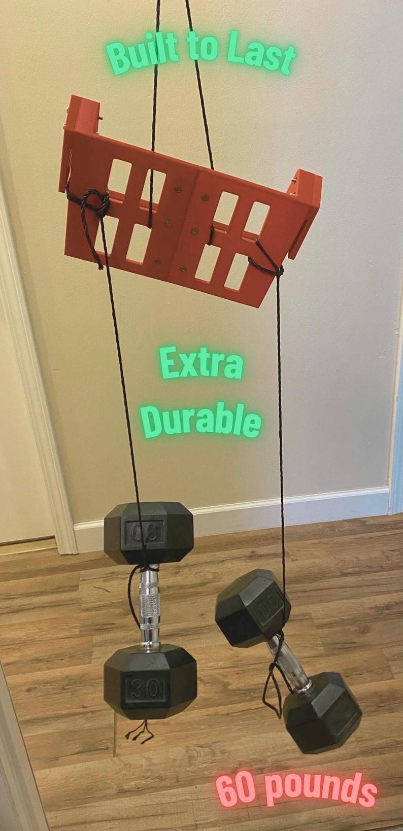 May include: An orange weight rack with two black dumbbells, each weighing 30 pounds, suspended by black ropes. The text "Built to Last" and "Extra Durable" are visible. The total weight is 60 pounds.