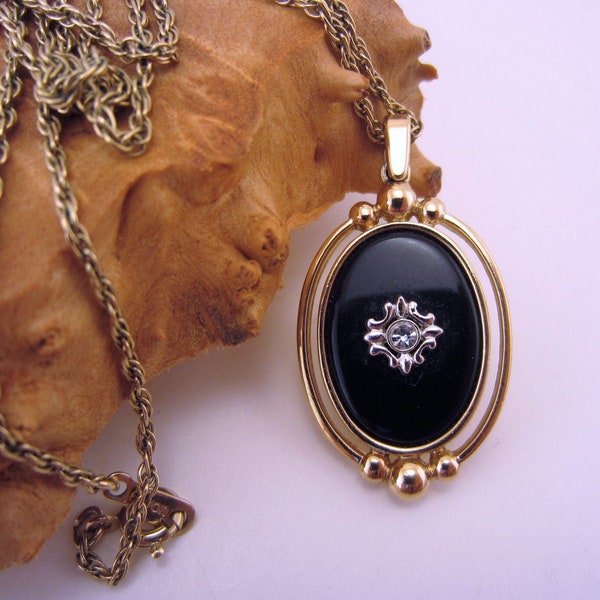 Vintage Avon jewelry. Black and gold pendant. Reversible pendant. Clear rhinestone. Long necklace. Gold rope chain.