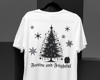 May include: White t-shirt with a black and white illustration of a Christmas tree with skulls, crosses, and moons. The text "Festive and Frightful" is printed below the tree.