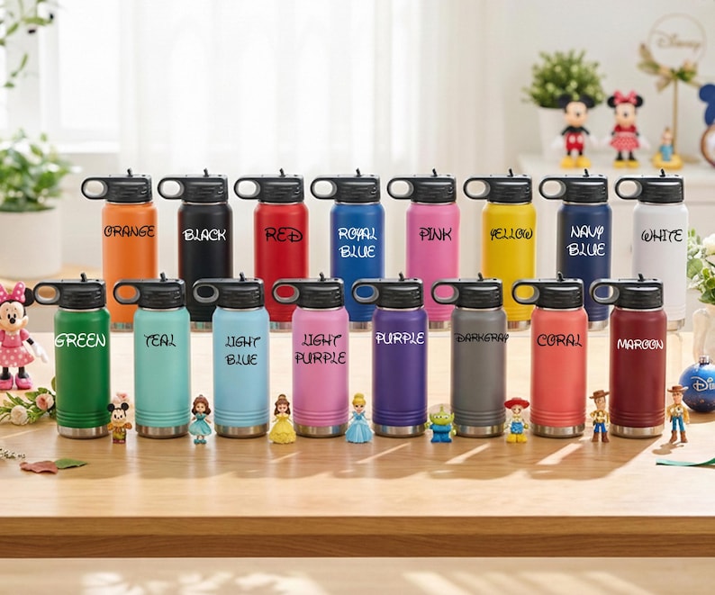 Puede incluir: Una colecci&oacute;n de botellas de agua aisladas de colores vibrantes, incluyendo naranja, negro, rojo y verde. Cada botella tiene una tapa negra y una etiqueta con un nombre de color a juego. Las botellas est&aacute;n dispuestas sobre una superficie de madera.