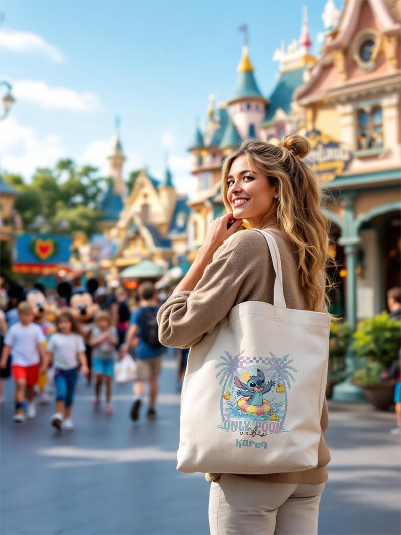 May include: A beige canvas tote bag featuring a colorful graphic of Stitch from Lilo & Stitch in a pool floatie, with palm trees and the text "Only Pool Vibes Karen". The bag is carried by a person in a theme park.