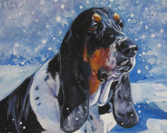 May include: A painting of a Basset Hound in a snowy scene. The dog has black, white, and brown fur, with long, floppy ears. Snowflakes fall around the dog, and the background is a light blue. The artist's name, L.A. SHEPARD ART, is at the bottom.