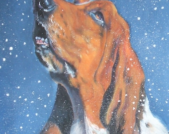 May include: A painting of a Basset Hound looking upwards with its mouth open, as if howling. The dog has brown and white fur, with long, floppy ears. White snowflakes are falling against a dark blue background.