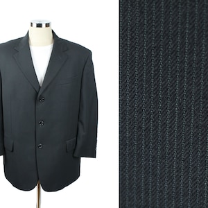 May include: A black blazer with a three-button closure and a pinstripe pattern.