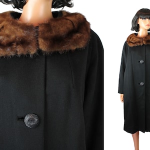 May include: A black wool coat with a brown fur collar. The coat has a single button closure and a long, straight silhouette.