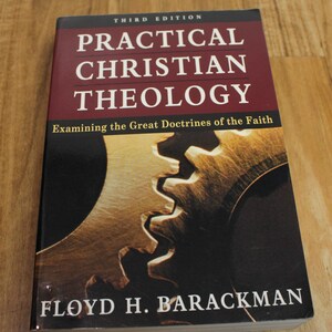 May include: A hardcover book titled "PRACTICAL CHRISTIAN THEOLOGY" with the author's name "FLOYD H. BARACKMAN" in white text. The cover is primarily burgundy with a gear graphic and the text "Examining the Great Doctrines of the Faith".