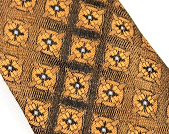 May include: A brown and black patterned tie with a geometric design. The pattern features small white accents.