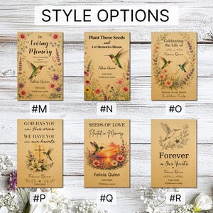 May include: Six rectangular memorial seed packet designs on kraft paper, labelled #M through #R. Each features hummingbird illustrations, floral motifs, and personalised text like In Loving Memory, Plant These Seeds, and Forever in Our Hearts.