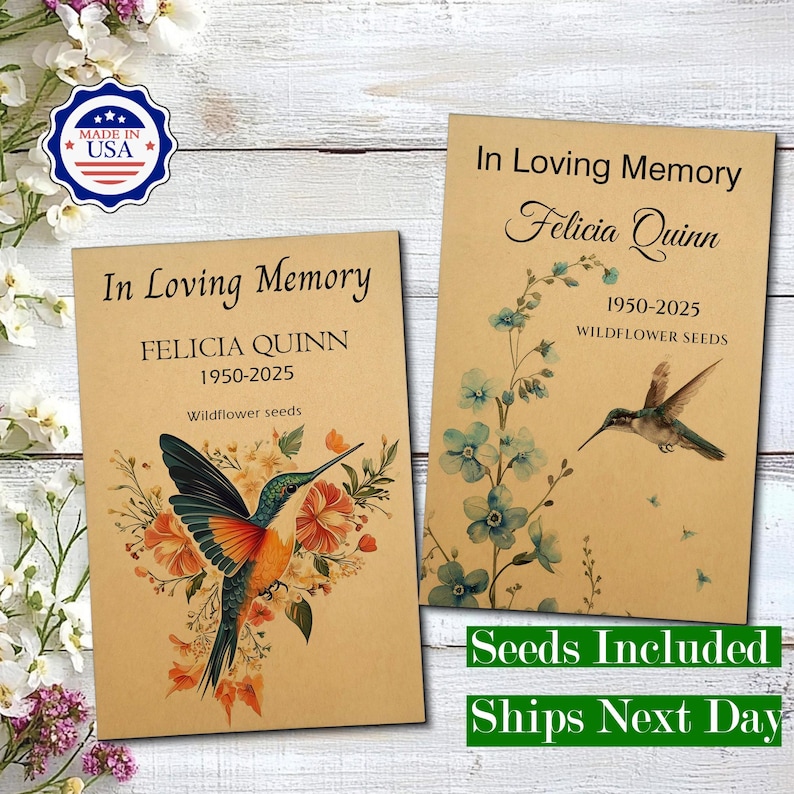 May include: Two rectangular tan paper packets labelled In Loving Memory for Felicia Quinn 1950-2025 Wildflower seeds. One packet features a colourful hummingbird with orange and green flowers, the other a blue floral stem and a flying hummingbird.