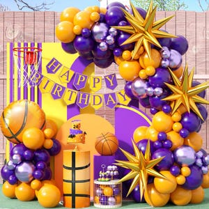May include: Purple and yellow balloons with gold star decorations and a banner that says "Happy Birthday". There is a basketball themed cake and a basketball themed pedestal.