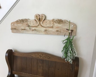 Large wooden coat rack. Swans and roses, white washed large coatrack, coat hanger, entry rack, with wooden pegs.