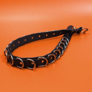 The Havoc Belt - angled view of the welded nickel D-rings riveted along the 1.5 inch black leather strap