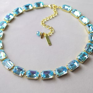 May include: A white ceramic mug with a black handle and the text "But First, Coffee" in a black, bold font. The mug is sitting on a wooden surface. The mug is 4 inches tall.