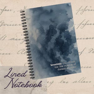 May include: A spiral-bound lined notebook with a watercolor design in shades of blue. The cover features the word "brontide" with its definition. The words "Lined Notebook" are written in cursive at the bottom.