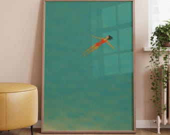 May include: A framed art print depicts a person floating in teal water. The person is wearing a red swimsuit. The artwork is in a wooden frame and is displayed against a light pink wall. A yellow ottoman and plants are in the foreground.