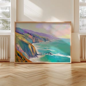 May include: A framed landscape painting depicts a coastal scene with cliffs, ocean, and sky. The artwork features vibrant colors, including shades of green, blue, purple, and orange. The painting is displayed on a wooden floor, with windows and radiators in the background.