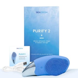 May include: A blue facial cleansing brush with a silver handle and a USB charging cable. The product is labeled "PURIFY 2" and "SKIN FRESH PARIS". The packaging includes a box and a smaller card with the product name and logo.
