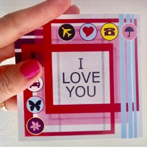 May include: Red and white card with a pink and blue plaid pattern. The card says "I love you" in a white box. There are small icons around the border of the card, including a plane, a heart, a phone, an umbrella, a car, a butterfly, and a flower.