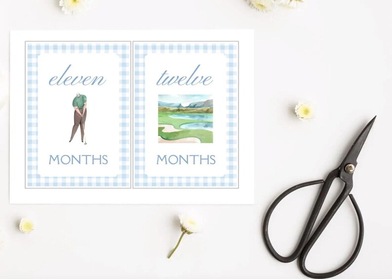 May include: Two printable cards with a blue and white gingham pattern. The first card says "eleven months" and features a golfer. The second card says "twelve months" and features a watercolour illustration of a golf course.