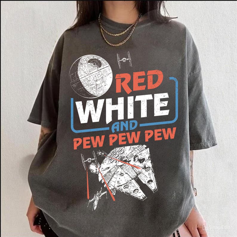 May include: A gray t-shirt with a graphic print of a Death Star, a spaceship, and the text "Red White and Pew Pew Pew".