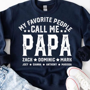 May include: Navy blue sweatshirt with white text that reads "My Favourite People Call Me Papa Zack Dominic Mark Joey Gianna Anthony Marissa".