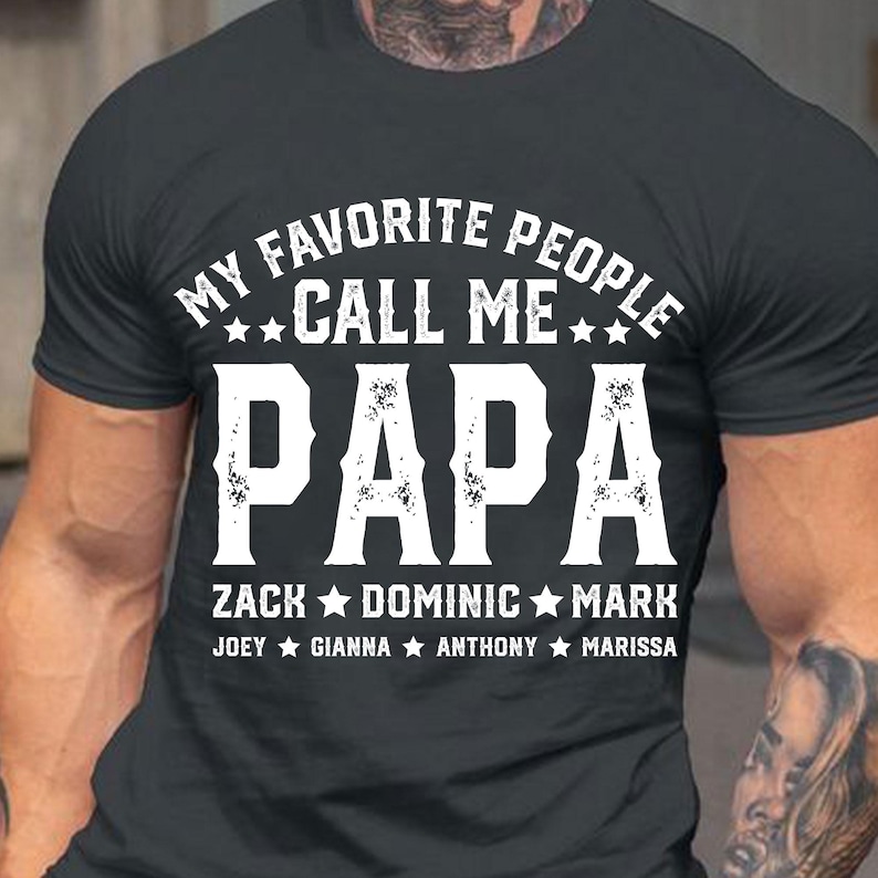 May include: Black t-shirt with white text that reads "My Favourite People Call Me Papa Zack Dominic Mark Joey Gianna Anthony Marissa".