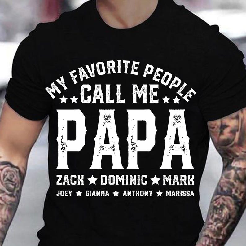 May include: Black t-shirt with white text that reads "My Favourite People Call Me Papa" with a list of names below: Zack, Dominic, Mark, Joey, Gianna, Anthony, Marissa.