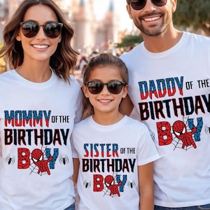 May include: A family of four wearing white t-shirts with a Spiderman theme. The shirts say "Mommy of the Birthday Boy", "Daddy of the Birthday Boy", "Sister of the Birthday Boy", and a Spiderman graphic.
