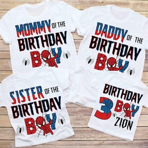 May include: Four white t-shirts with red, blue, and black Spiderman graphics. The shirts say "Mommy of the Birthday Boy", "Daddy of the Birthday Boy", "Sister of the Birthday Boy", and "Birthday Boy Zion".