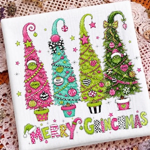May include: A white fabric featuring four stylized Christmas trees in pink, teal, lime green, and dark green. Each tree is decorated with ornaments, bows, and Grinch faces. The text "MERRY GRINCHMAS" is printed in colorful, patterned letters below.