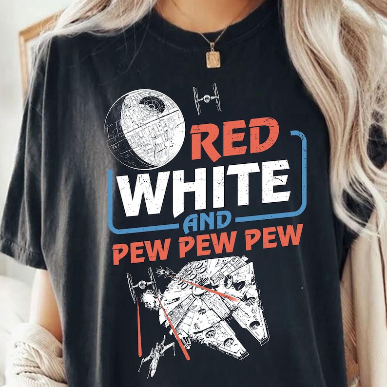 May include: Black t-shirt with a white and red graphic design featuring the words "Red White and Pew Pew Pew" and a spaceship and Death Star.