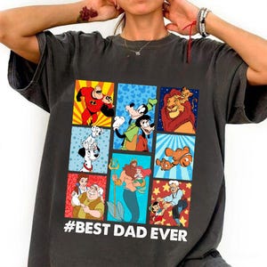 May include: A dark gray t-shirt with a colorful graphic of various Disney characters in a grid pattern. The text "#BEST DAD EVER" is printed below the graphic.