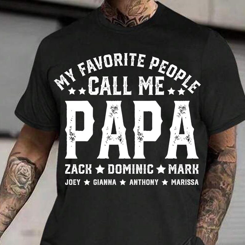 May include: Black t-shirt with white text that reads "My Favourite People Call Me Papa Zack Dominic Mark Joey Gianna Anthony Marissa".