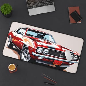 May include: A red and white classic car illustration on a rectangular mousepad. The car has chrome wheels and a black stripe down the hood. The license plate reads "0511 69 40". A computer mouse is on the mousepad.