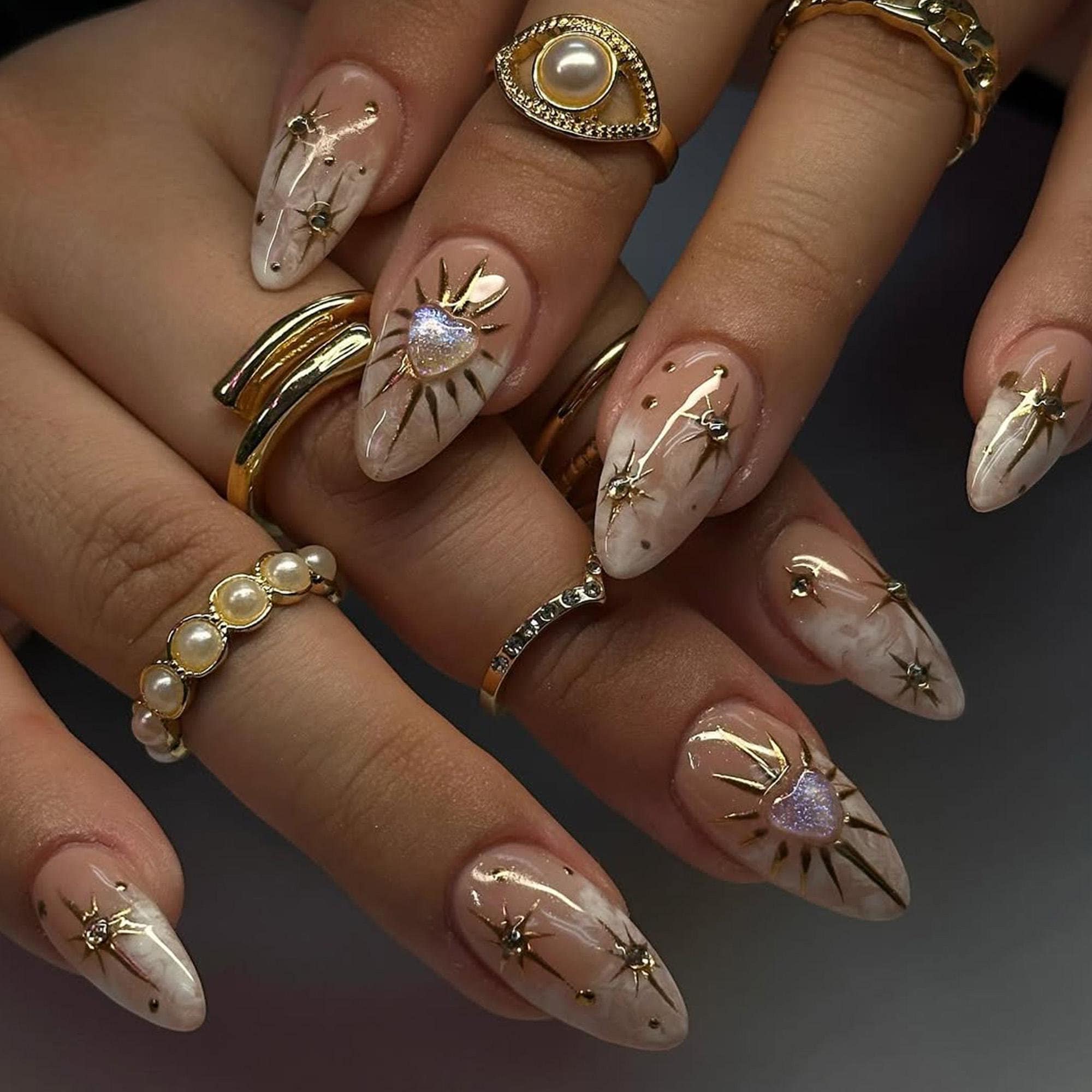 Elegant nude and gold nails with metallic accents