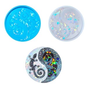May include: Three round resin molds, one blue, one white, and one with a black and white yin yang design with a gecko on each side. The molds are for making resin crafts.