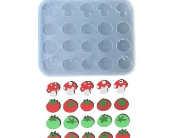 Puede incluir: Un molde de silicona con 24 cavidades para hacer manualidades de resina. El molde presenta formas de champiñones y tomates. Hay 24 piezas de resina terminadas en la imagen, incluyendo champiñones rojos y blancos y tomates rojos y verdes.