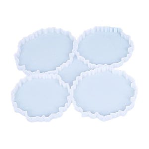May include: Set of four white silicone coaster moulds with a scalloped edge.