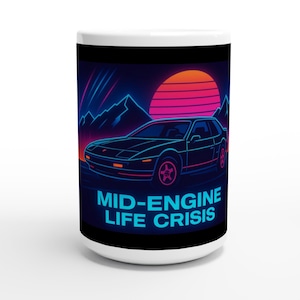 May include: White ceramic mug with a black car design, neon sunset, and mountain backdrop. The text "MID-ENGINE LIFE CRISIS" is in blue. A fun gift for car enthusiasts. The mug is approximately 10 cm tall.
