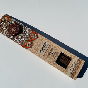 May include: A box of 40 incense sticks with a mandala design on the front. The box is brown and has the text "Mandala Scents" and "Incense Sticks" printed on it. The scent is Patchouli.